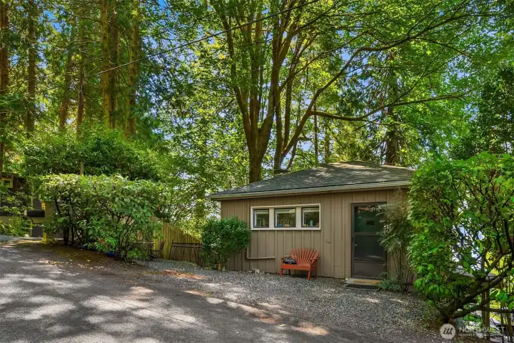 Guest house with a private parking spot and private patio area to the left. One bedroom with full bath, kitchen and living area with views of the Sound.