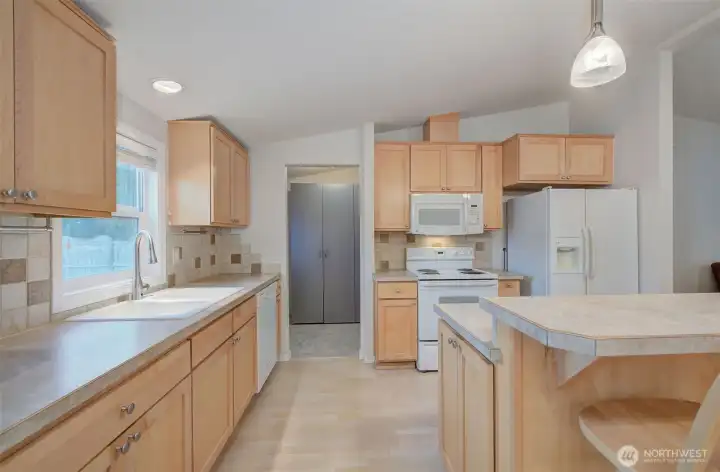 Another angle of the kitchen looking towards the old laundry room. It's now a large pantry area and the laundry is in the shop with the 1/2 bath.