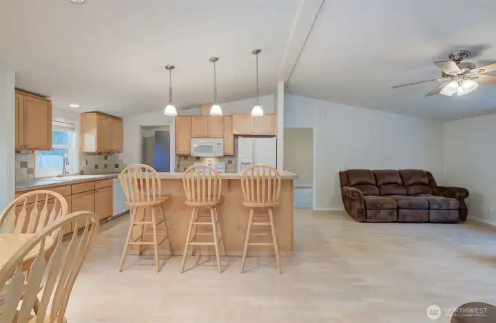 Kitchen and living room. Primary bedroom door is straight ahead.