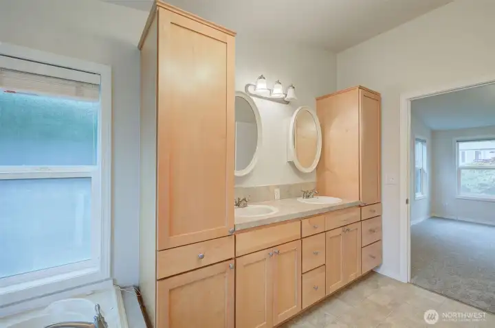 Double sinks and lots of storage in primary bathroom.