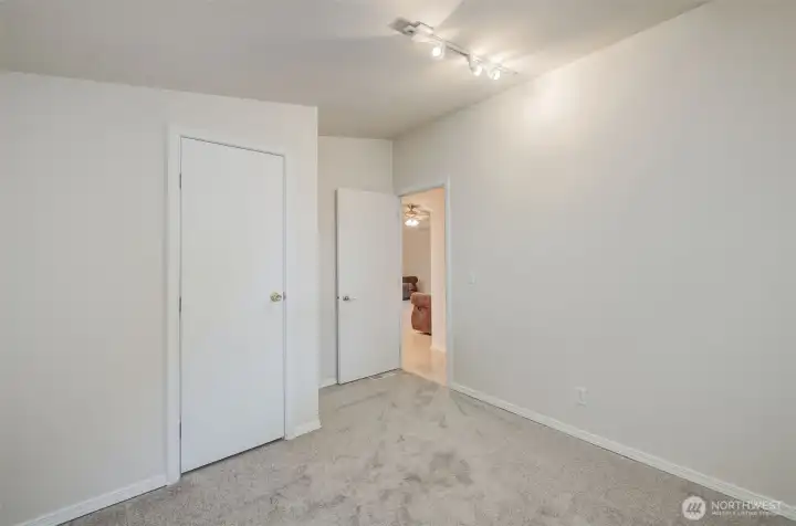 Bedroom #3 with new carpet and closet.