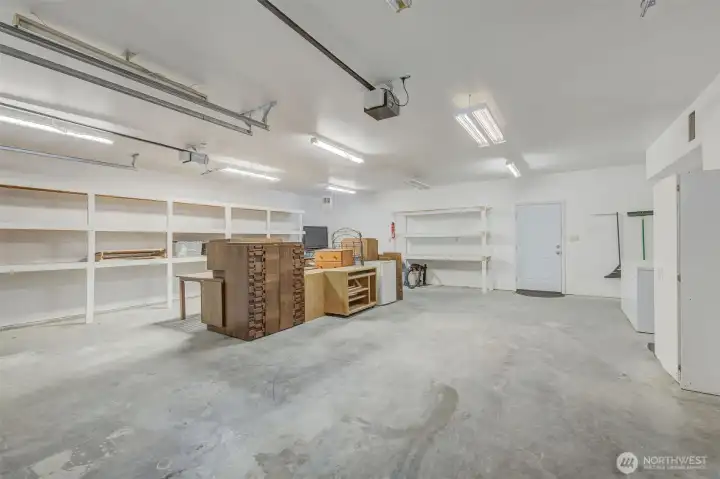 966 sq foot heated shop. Lots of shelving and also 1/2 bath in shop. Door to the back yard is straight ahead. There's also another door from the old laundry room to the back yard.