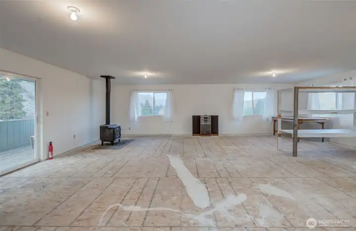 HUGE upstairs bonus room with woodstove and lots of natural light.