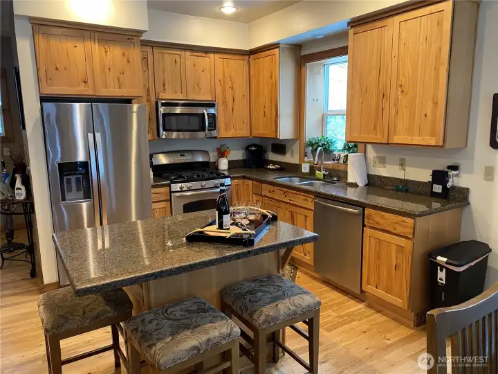 Full kitchen with hickory cabinets, stainless appliances and granite counters. Hickory cabinets add to the cabin feel.