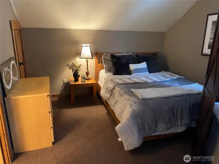Upper level master bedroom - view of secondary queen bed on the other side of the room with divider.