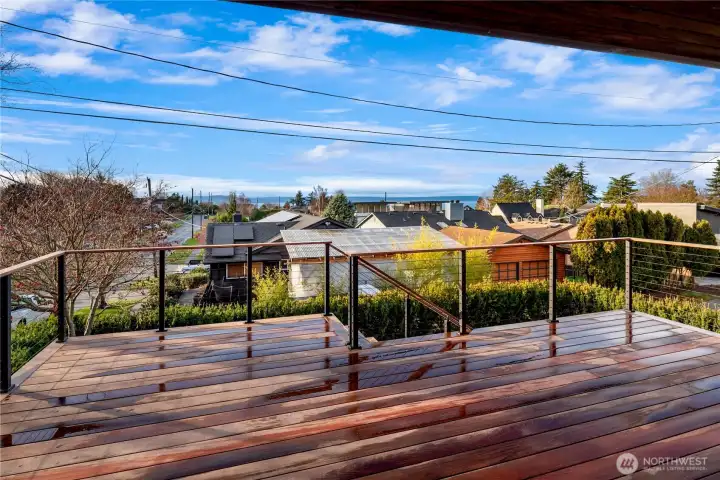 Expansive ipe deck with sleek railings offers the perfect perch for morning coffee, sunset dinners and outdoor entertaining.
