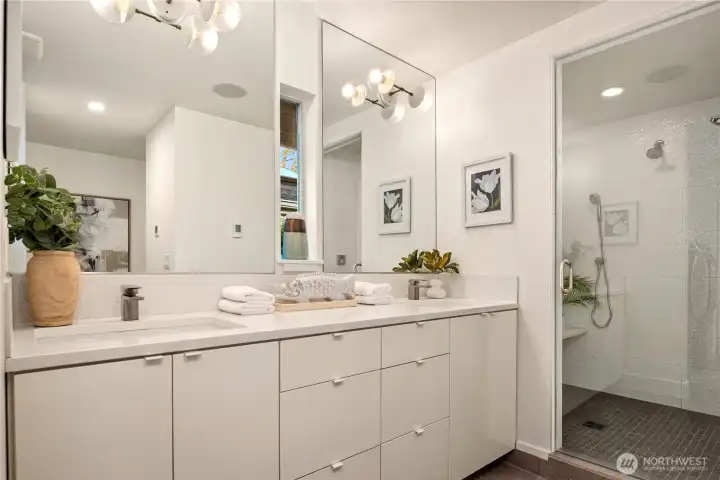 A spa-inspired primary bath with dual vanity, clean modern finishes and a spacious steam shower.