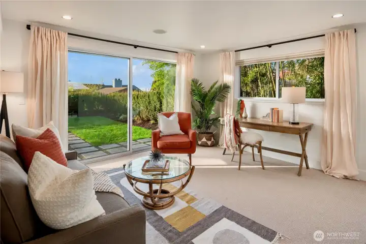 Versatile lower-level living 5th bedroom or potential media room, guest retreat or home office, with direct access to the backyard.