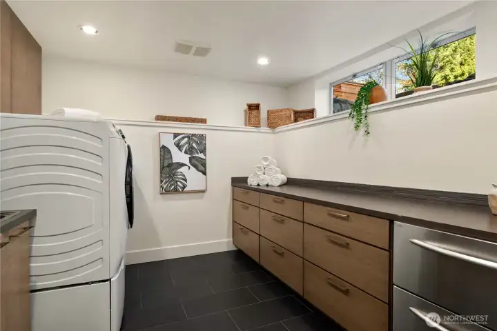 Well-appointed laundry room with abundant storage, generous counter space and a thoughtful design throughout.