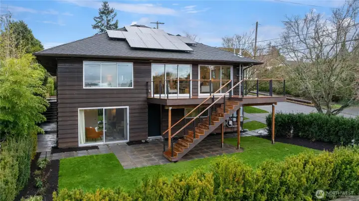 Striking modern lines meet indoor-outdoor living, with an elevated deck and easy access to the lush, private backyard.