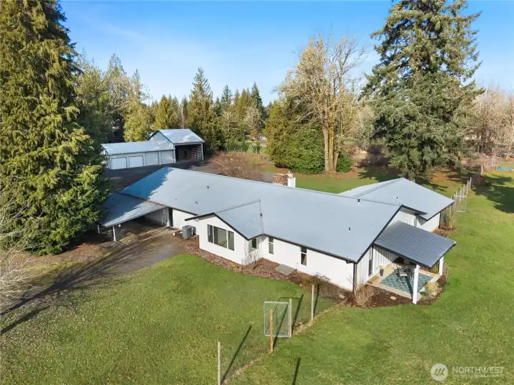 Another aerial shot taken from the back of your home. Covered patio to the right, large 2,000+ sqft shop located at the rear. Tons of natural light and privacy. Notice the immaculate metal roof that will last for years to come.