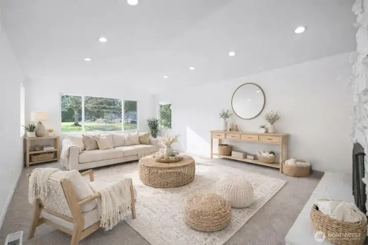 Welcome to your bright and airy living room with vaulted ceilings, recessed lighting, a cozy wood burning fireplace. Tons of natural light with abundance of windows and space. Photo is virtually staged.