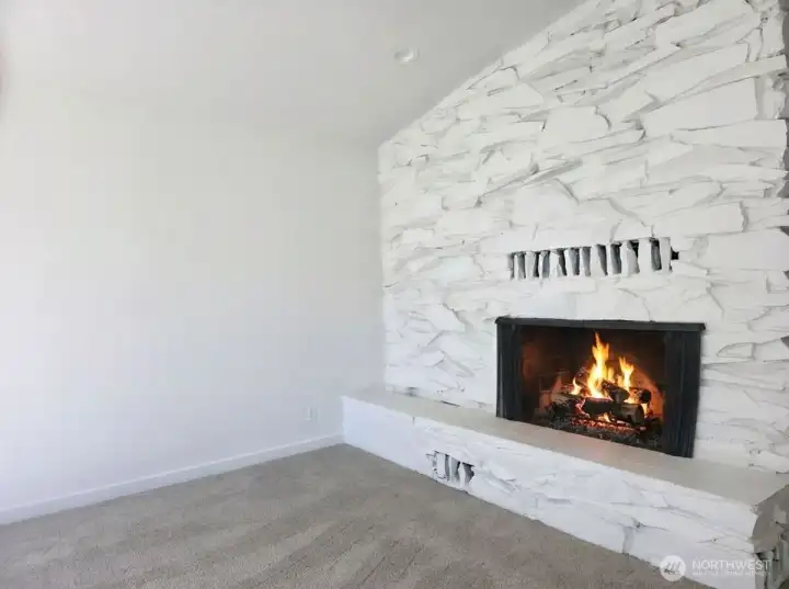 Statement wood burning fireplace will keep you warm and cozy. Solid stone surround with fireplace ledge.