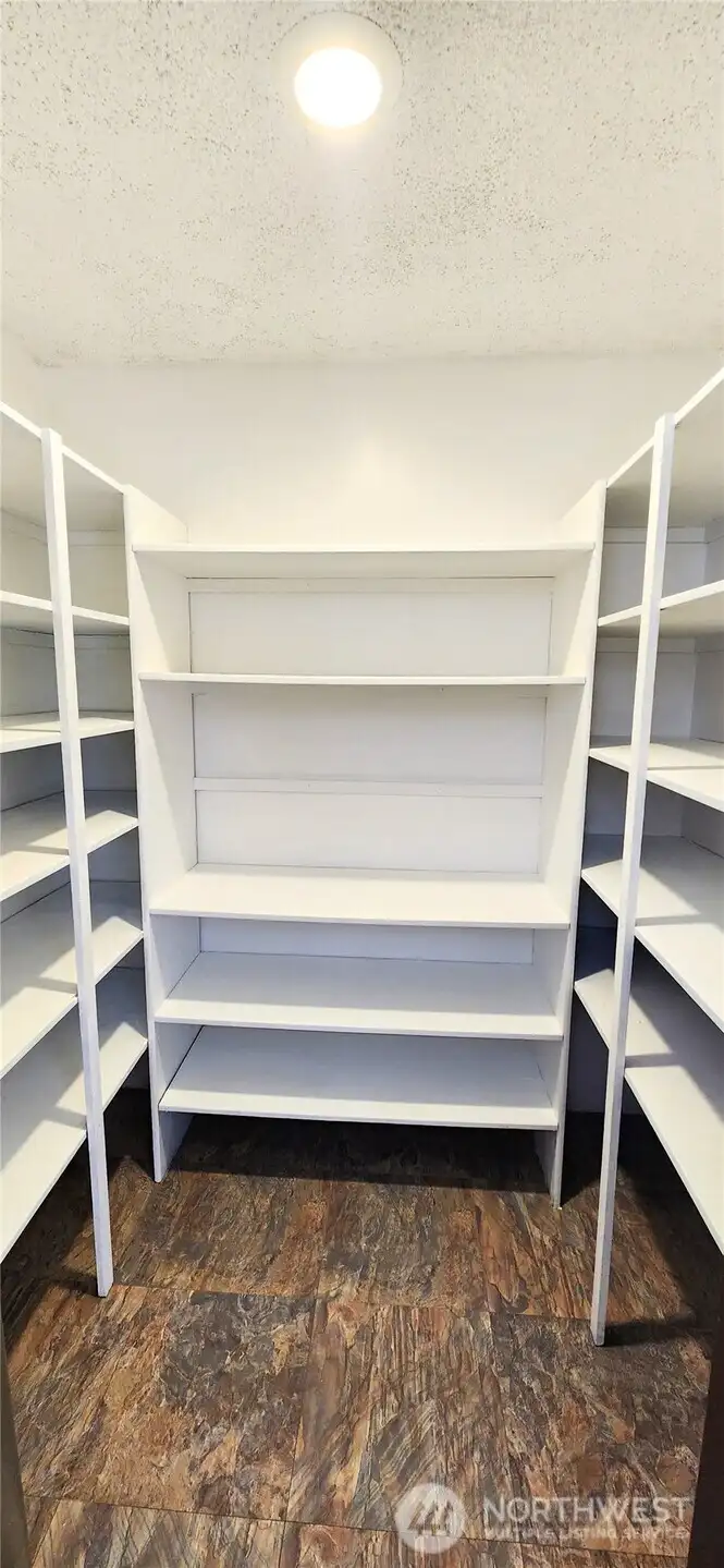 Full sized walk in pantry with built in shelving and storage space. An abundance of storage exists in this kitchen.