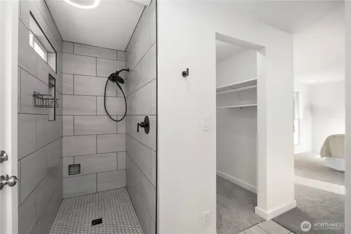 Beautiful floor to ceiling tiled walk in shower with multiple built in storage nooks. High end finished and LED lighting in shower with built in speaker and night light function. One of two walk in closets lies directly next to shower for ease and convenience.