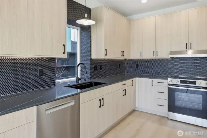 Contemporary accents wrap around this well- lit open kitchen.