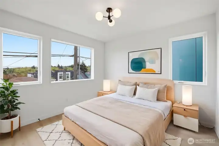 Light-filled bedroom with clean modern design, mini-split AC, and flexible space for guests, office, or nursery.