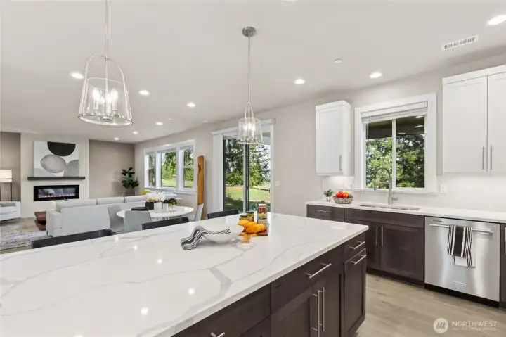 Same home from another community showing kitchen overlooking informal dining + great room.  This photo has upgrades, home for sale will have all white cabinetry throughout.