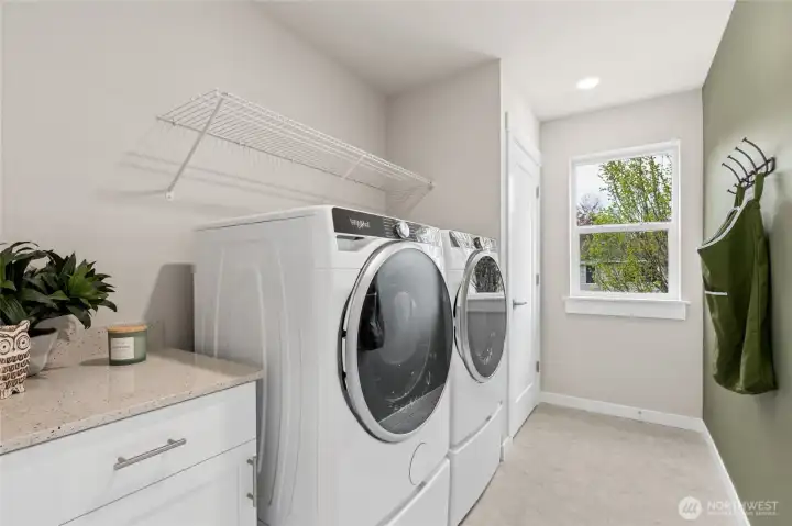 Top floor laundry room with folding bench and window - makes doing laundry a delight!
