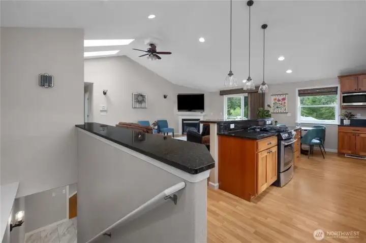 Vaulted ceiling with skylights and ceiling fan.
