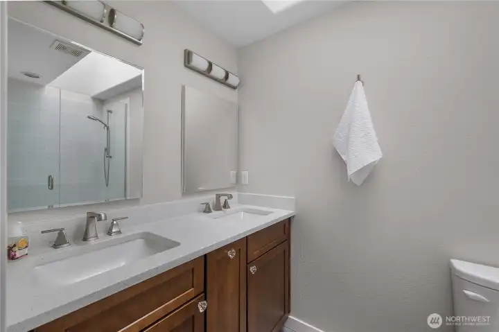 Newly update primary bathroom with walk in shower and two sinks