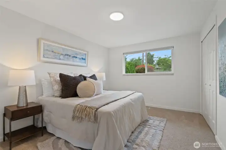 Bedroom 2 on main level - double closet doors and fresh paint, lighting and carpets. Bedroom 2 on main level - double closet doors and fresh paint, lighting and carpets.