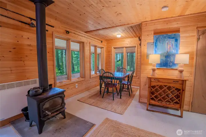 Wood stove heats the home and a wall heater in the bath.