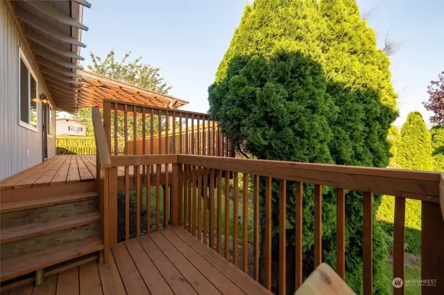 Multi level back deck has stairs to back yard