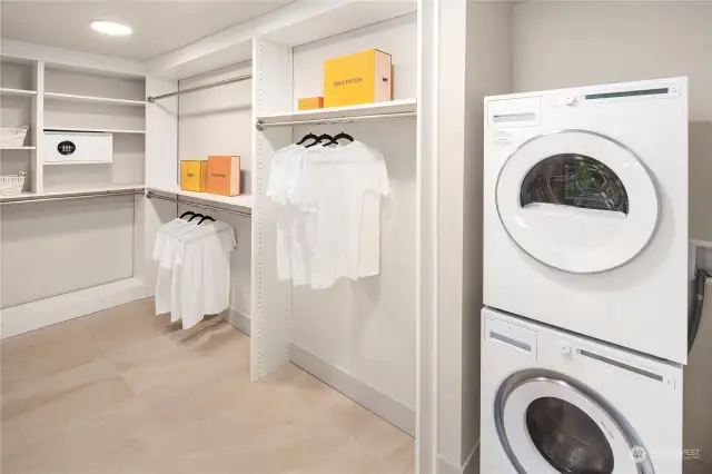 Walk-in closet and new washer and dryer in primary bedroom