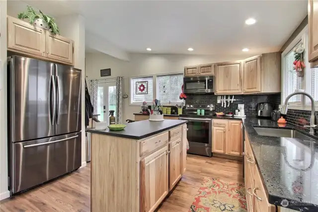 Main house kitchen view, patio doors lead out the back, love all the counter space!