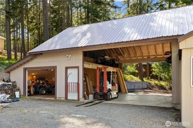 Covered Carport with storage above and garage access.