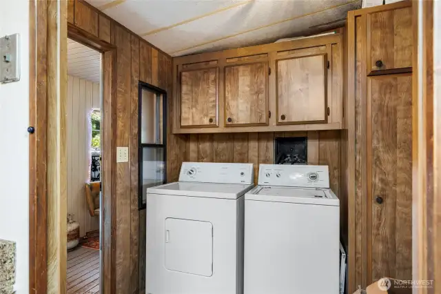 Laundry room with additional fridge that stays.