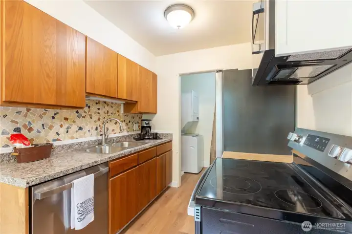 Kitchen has new countertop, all new appliances, including sink and disposal.  Pantry includes new hot water tank, stackable washer and dryer and storage space for pantry items.
