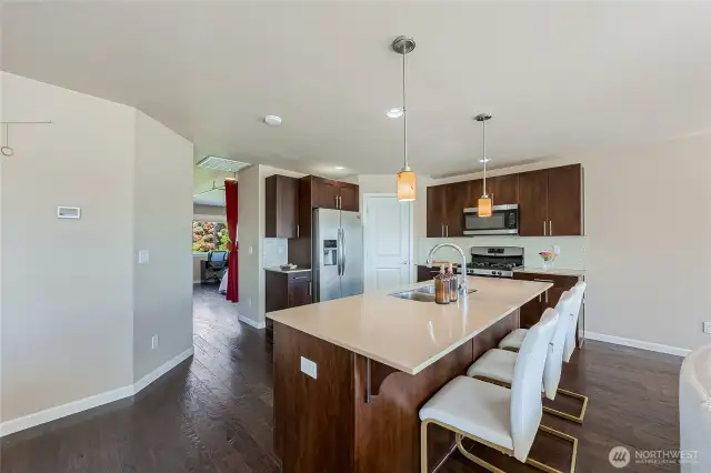 Quartz countertop kitchen island that seats several.