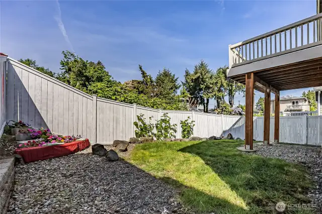 Enter the backyard through any of two gates on sides of house. Easy maintenance and fengshui with this rock garden and corner floral platform with seating. More outdoor covered seating possible under the deck. Low maintenance home with gutter guards installed.
