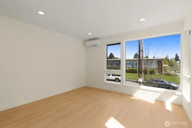 Photos of model home with similar finishes & floor plan. Sun-drenched corner room with warm wood flooring and expansive windows for natural light all day.