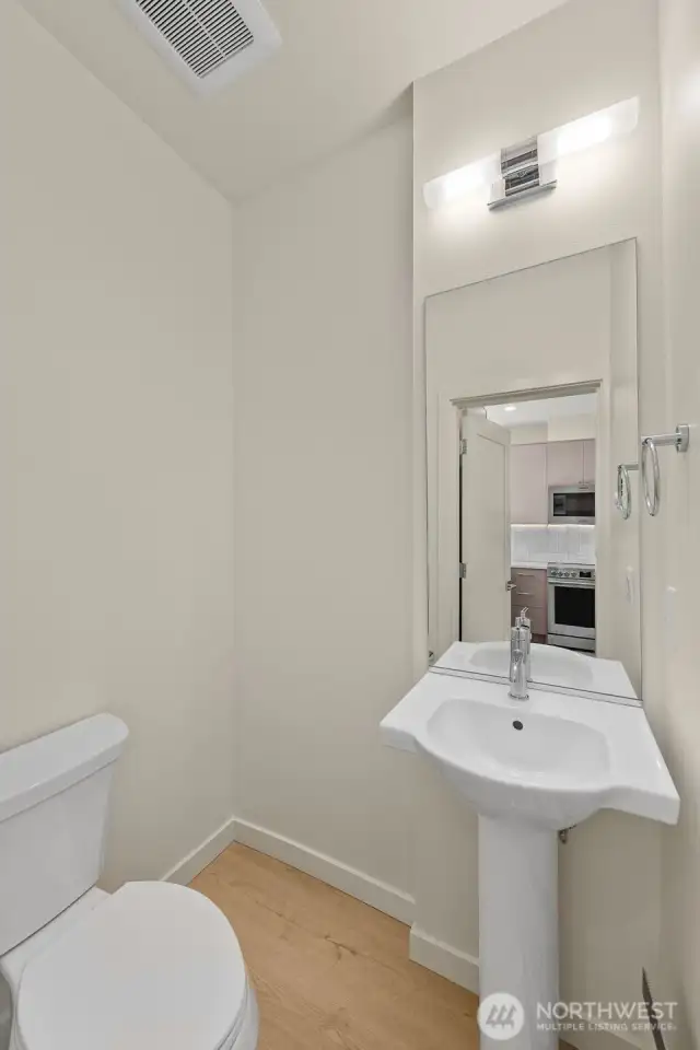 Photos of model home with similar finishes & floor plan. Powder bath with timeless finishes and space-saving style.