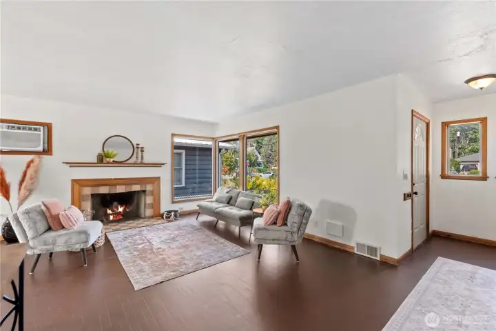 Bright and open living room features large windows that frame the outdoor views