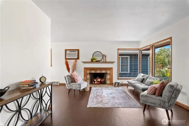 Step into an inviting living room that’s full of natural light and features a cozy fireplace, creating the perfect space to relax and unwind.
