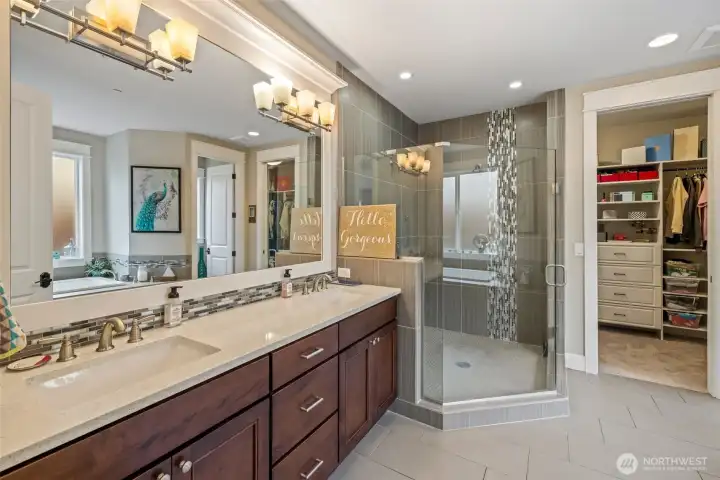 Large primary bathroom with dual vanities.