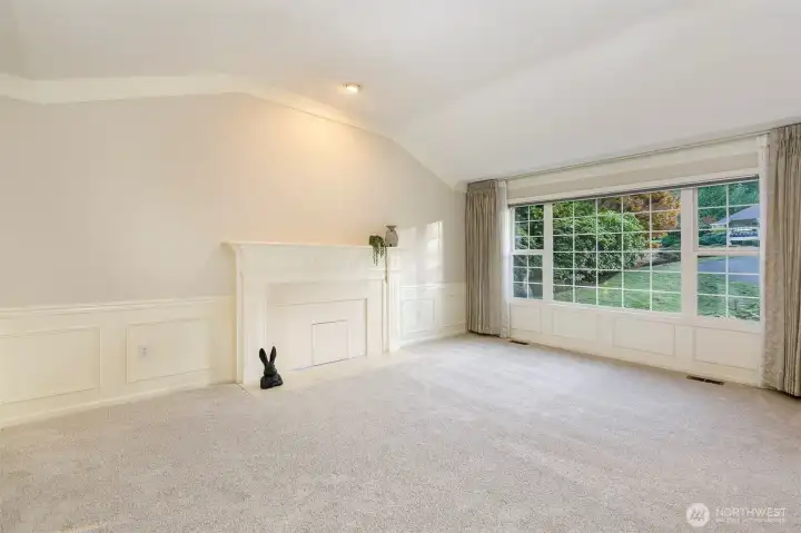 Another view of the formal living room and fireplace.