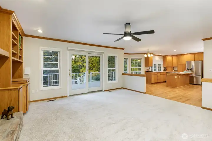 Spacious family room with the second fireplace on this floor and doors leading to the deck beyond.