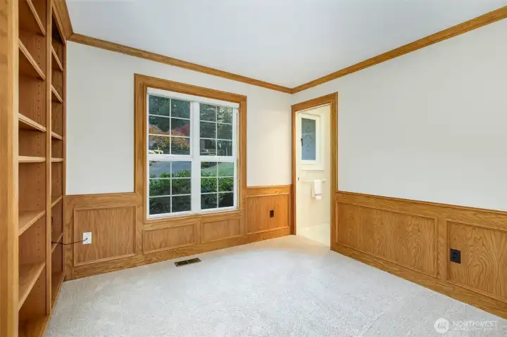 Den off the main entry with access to the main floor 3/4 bath in the background.    Yes, built-in shelving here too.   This house has it all!