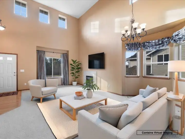 Soaring ceilings and elevated windows fill the main living area with natural light