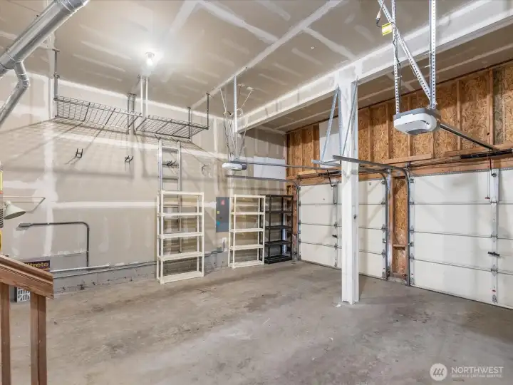Oversized two-car garage with additional space for storage or a workshop.