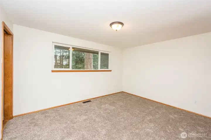 Primary bedroom window overlooks the back property.