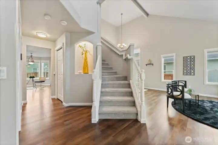 The staircase leads upstairs to plush new carpet installed in 2022, adding comfort and a fresh look to the upper level.