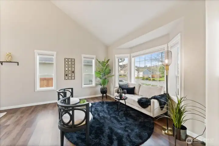 The freshly painted interior is complemented by wood-wrapped windows throughout, filling the home with abundant natural light.