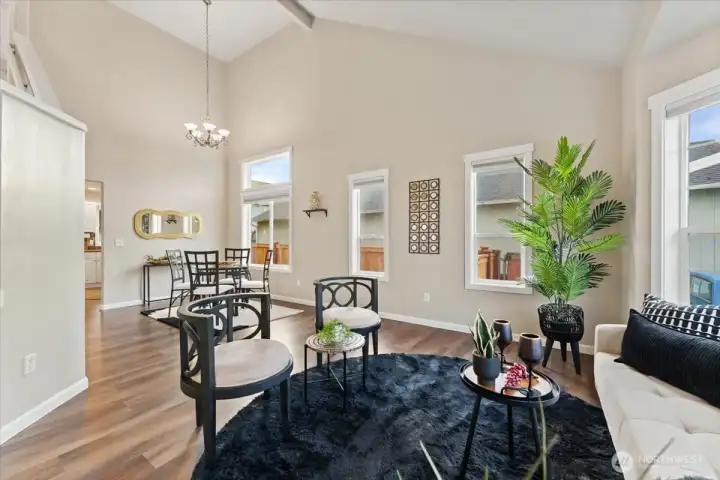 The combined living and dining room offers a spacious, open layout with high ceilings, ideal for both everyday living and entertaining.