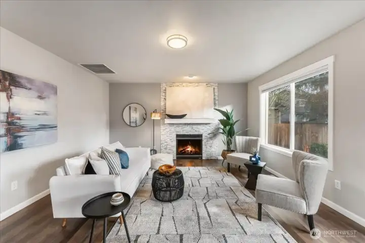 A tiled, stone-front gas fireplace anchors the family room, adding warmth and character.